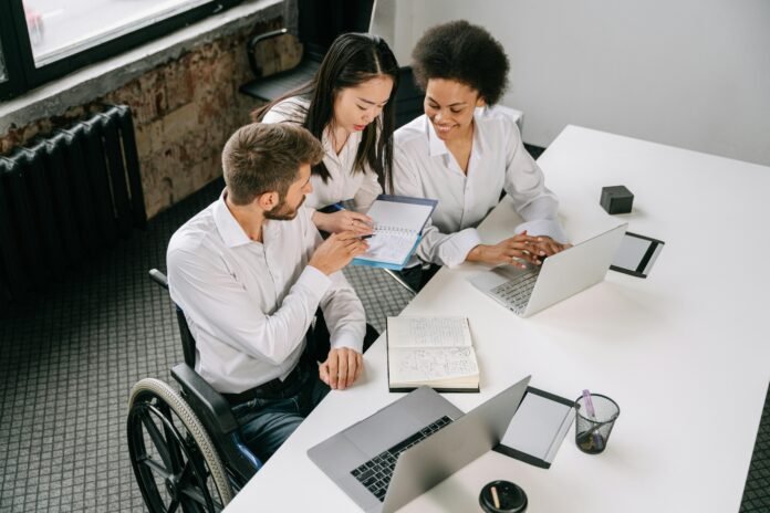 Free Employees Looking at the Notepad  Stock Photo